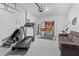Garage with treadmill, basketball game, and sofa at 9355 Sommerset Hills Dr # 9355, Davenport, FL 33896