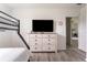 Bedroom with large TV, dresser, and access to other rooms at 9355 Sommerset Hills Dr # 9355, Davenport, FL 33896