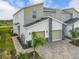 Modern two-story townhome with a two-car garage and stone accents at 9355 Sommerset Hills Dr # 9355, Davenport, FL 33896
