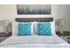 Bedroom with a queen bed and teal pillows at 9355 Sommerset Hills Dr # 9355, Davenport, FL 33896