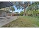 Large backyard with lush landscaping and screened patio at 3722 Paige St, Port Orange, FL 32129