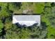 Aerial view of a home with a metal roof surrounded by trees at 2795 Absher Rd, Saint Cloud, FL 34771