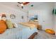 Bright bedroom with a comfortable bed, neutral decor, and large TV at 4222 Paragraph Dr, Kissimmee, FL 34746