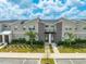 Modern townhouses with gray siding and landscaping at 4222 Paragraph Dr, Kissimmee, FL 34746