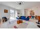 Bright living room with blue sofa, geometric rug, and access to backyard patio at 4222 Paragraph Dr, Kissimmee, FL 34746