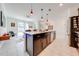 Modern kitchen with island, stainless steel appliances, and stylish pendant lighting at 4222 Paragraph Dr, Kissimmee, FL 34746