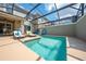 Private screened in pool and patio with loungers at 4222 Paragraph Dr, Kissimmee, FL 34746