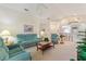 Bright and airy living room with teal reclining furniture at 405 High Vista Dr, Davenport, FL 33837