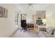 Home office with window, desk, and view of living room at 405 High Vista Dr, Davenport, FL 33837