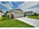 Attached garage with driveway and landscaping at 405 High Vista Dr, Davenport, FL 33837