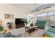 Living room with teal couches, TV, and high ceiling at 405 High Vista Dr, Davenport, FL 33837