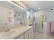 Bathroom with double vanity, shower and mirror at 405 High Vista Dr, Davenport, FL 33837