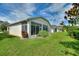 Screened enclosure in backyard with lawn at 405 High Vista Dr, Davenport, FL 33837
