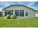 Screened enclosure in backyard with lawn at 405 High Vista Dr, Davenport, FL 33837