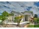 Tan house with landscaping and a walkway at 405 High Vista Dr, Davenport, FL 33837