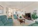 Spacious living area with teal sofas and wood coffee table at 405 High Vista Dr, Davenport, FL 33837