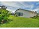 Screened enclosure in backyard with lawn at 405 High Vista Dr, Davenport, FL 33837