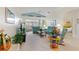 Bright living room with teal couches and access to a sunroom at 405 High Vista Dr, Davenport, FL 33837