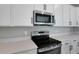 Stainless steel appliances and white cabinets in a modern kitchen at 1732 Carnelian St, Deland, FL 32720