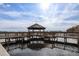 Wooden dock with gazebo offering scenic waterfront views at 13427 Blue Heron Beach Dr # 1901, Orlando, FL 32821