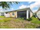 Backyard view showing home's exterior and screened porch at 2453 Yellow Brick Rd, Saint Cloud, FL 34772