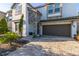 Two story house with a brown garage door and stone accents at 9032 Flamingo Key Way, Kissimmee, FL 34747