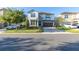 Two-story house with stone accents, a large garage, and landscaping at 9032 Flamingo Key Way, Kissimmee, FL 34747