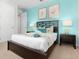 Bedroom with a queen-size bed and light blue walls at 9032 Flamingo Key Way, Kissimmee, FL 34747