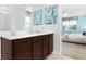 Main bathroom with vanity, mirror, and bedroom view at 9032 Flamingo Key Way, Kissimmee, FL 34747