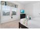 Bedroom with a king-size bed, TV, and large window at 9032 Flamingo Key Way, Kissimmee, FL 34747