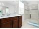 Bathroom with wood vanity, shower, and large mirror at 9032 Flamingo Key Way, Kissimmee, FL 34747