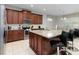 Modern kitchen with dark wood cabinets and granite island at 9032 Flamingo Key Way, Kissimmee, FL 34747