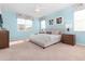 Main bedroom with king-size bed, light blue walls, and ceiling fan at 9032 Flamingo Key Way, Kissimmee, FL 34747