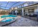 Screened-in pool and spa with patio furniture at 9032 Flamingo Key Way, Kissimmee, FL 34747