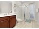 Bathroom with wood cabinets, a shower, and tile flooring at 9032 Flamingo Key Way, Kissimmee, FL 34747