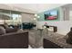 Living room with gray sofas, teal accents, and a large TV at 9032 Flamingo Key Way, Kissimmee, FL 34747