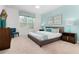Spacious main bedroom with large window, teal accents, and a king-size bed at 9032 Flamingo Key Way, Kissimmee, FL 34747