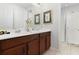 Bathroom with double vanity, shower, and neutral color palette at 9032 Flamingo Key Way, Kissimmee, FL 34747