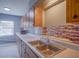 Kitchen features double sink, wood cabinets and tile backsplash at 1501 Ne 57Th St, Ocala, FL 34479