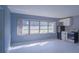 Light-filled living room with large windows and updated kitchen at 1501 Ne 57Th St, Ocala, FL 34479