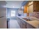 Kitchen with wood cabinets, tile backsplash and stainless steel sink at 1501 Ne 57Th St, Ocala, FL 34479