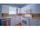 Small kitchen with white cabinets and granite counters at 1501 Ne 57Th St, Ocala, FL 34479
