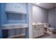 Small bathroom with toilet, sink, and built-in cabinets at 1501 Ne 57Th St, Ocala, FL 34479