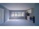 Open living space with large windows and a small kitchen at 1501 Ne 57Th St, Ocala, FL 34479