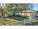 Tan block building with a white picket fence at 1501 Ne 57Th St, Ocala, FL 34479