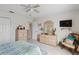 Bedroom with dresser, chair, and large closet at 241 Grosvenor Loop, Davenport, FL 33897