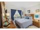 Guest bedroom with wood furniture and window views at 241 Grosvenor Loop, Davenport, FL 33897