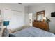 Spacious bedroom with double doors and dresser at 241 Grosvenor Loop, Davenport, FL 33897