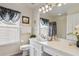 Clean bathroom with white vanity, shower, and window at 241 Grosvenor Loop, Davenport, FL 33897