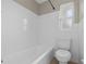 Simple bathroom with a toilet, bathtub, and window at 3210 Carleton W Cir, Lakeland, FL 33803